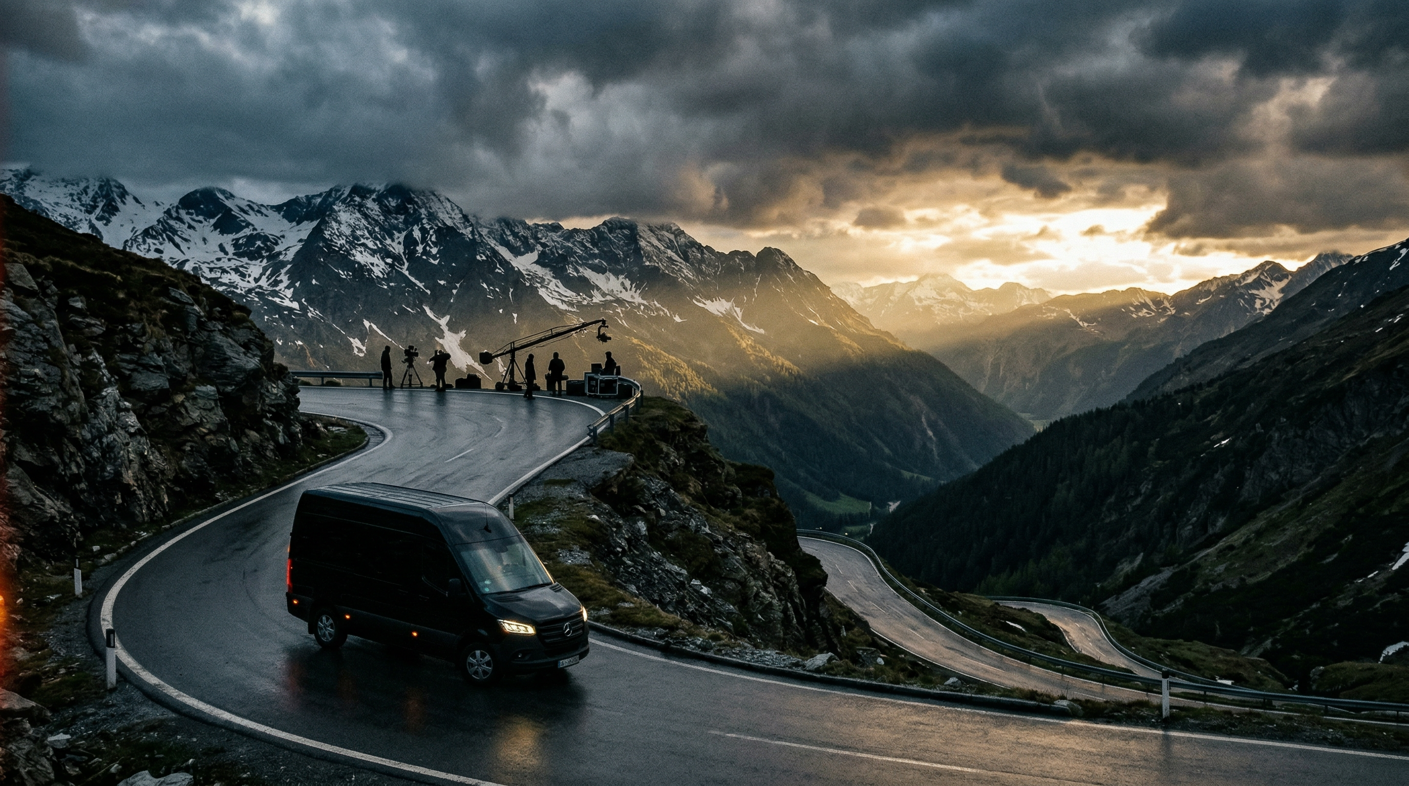 Black van on an Alpine road – film production in the background